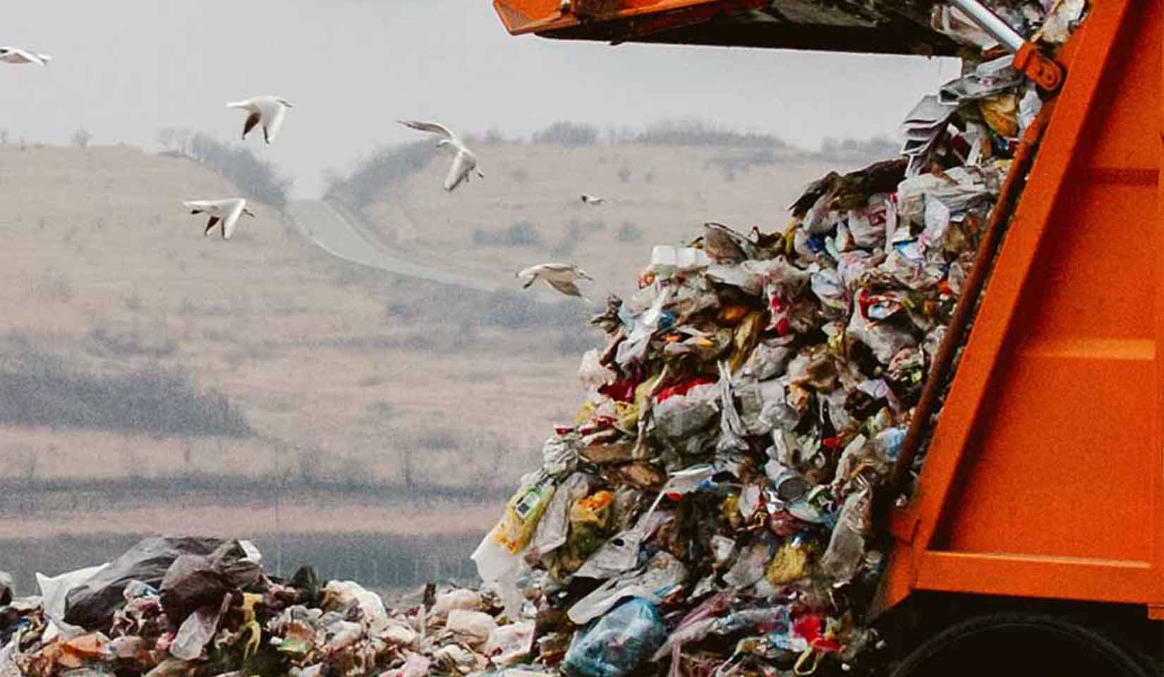 Trash being dumped out of a dump truck