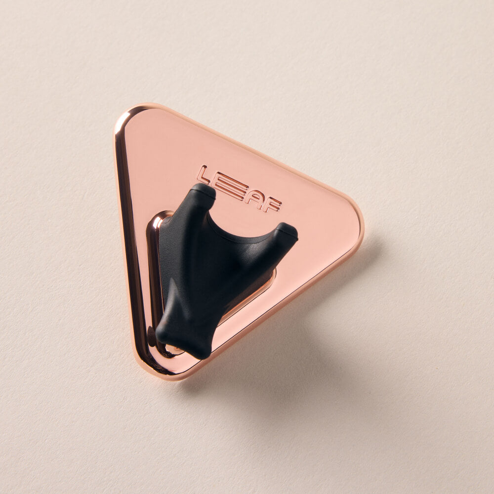 A rose gold razor shower holder