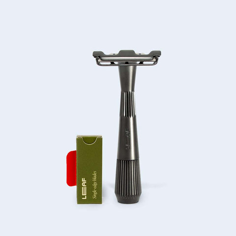 The Twig razor standing next to a pack of single-edge blades